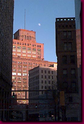 A waxing moon over a waning Hudson's Building